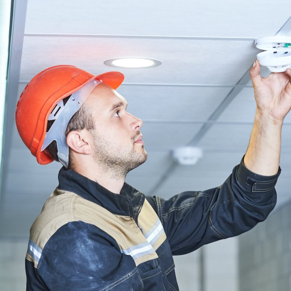 Worker_fixing_smoke_detector